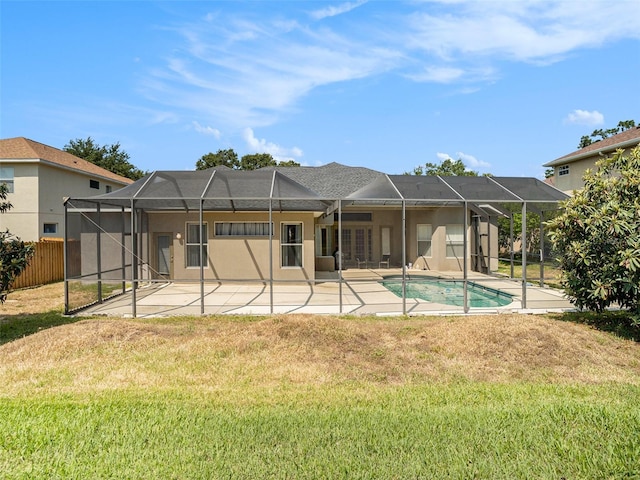 back of house featuring a patio, a yard, and glass enclosure