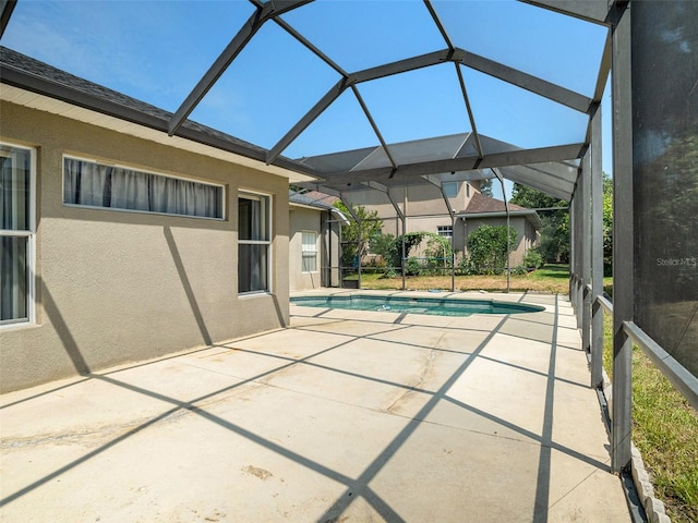 view of swimming pool with a lanai and a patio