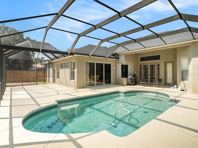 view of pool featuring a lanai, a patio area, and french doors