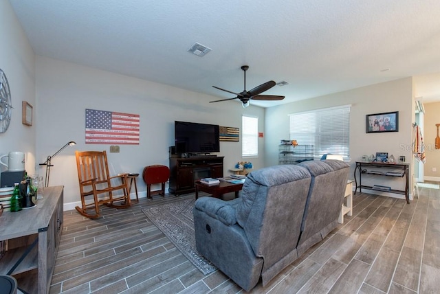 living room featuring ceiling fan and hardwood / wood-style floors