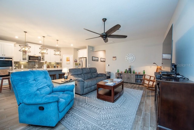 living room with dark hardwood / wood-style flooring and ceiling fan