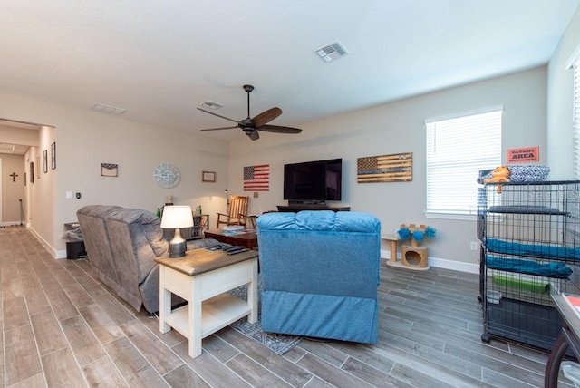 living room featuring ceiling fan and hardwood / wood-style flooring