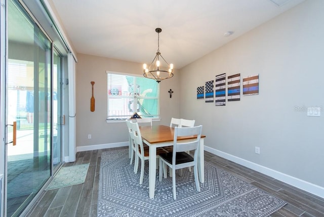 dining space featuring dark hardwood / wood-style flooring and an inviting chandelier