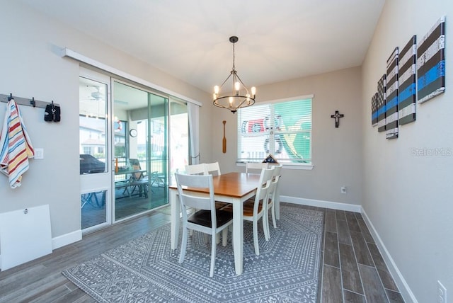 dining space featuring a notable chandelier and hardwood / wood-style floors