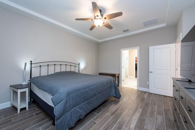 bedroom with ceiling fan and dark hardwood / wood-style floors