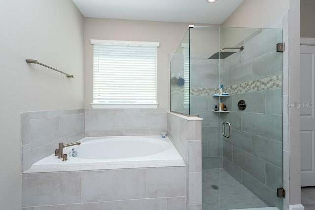 bathroom featuring shower with separate bathtub