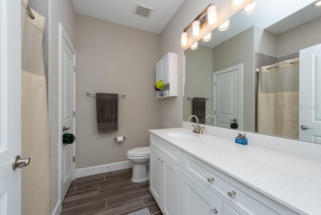 bathroom with vanity and toilet