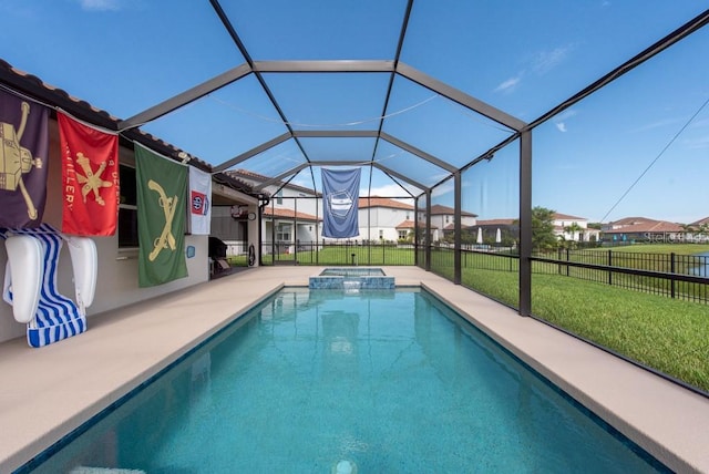 view of pool featuring glass enclosure, a yard, and a patio area