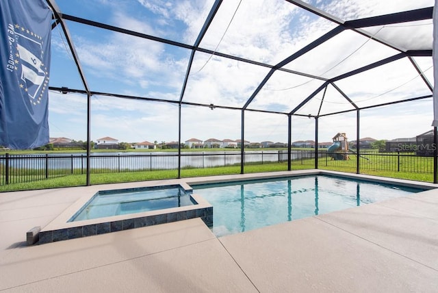 view of swimming pool featuring an in ground hot tub, a patio, and glass enclosure