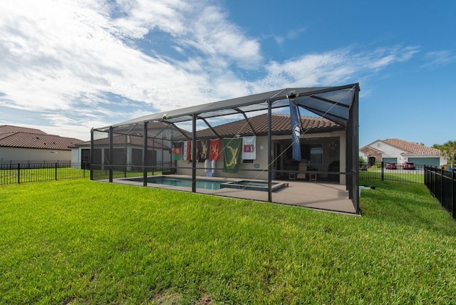 back of house with a lanai, a patio area, a fenced in pool, and a lawn