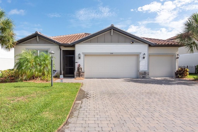 view of front of home featuring a garage and a front lawn