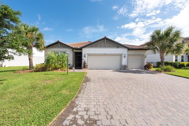 view of front of property with a garage and a front lawn