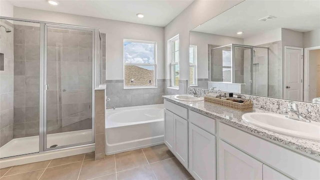 bathroom featuring separate shower and tub, tile patterned flooring, and vanity