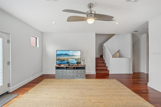 living room featuring dark hardwood / wood-style floors and ceiling fan