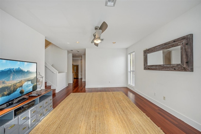 living room featuring ceiling fan and dark hardwood / wood-style flooring