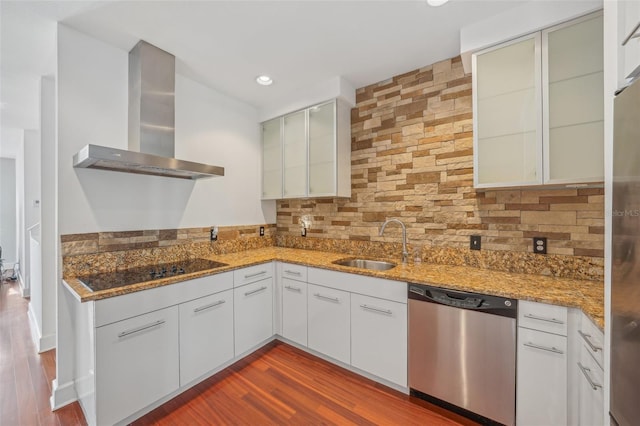 kitchen featuring sink, white cabinets, stainless steel dishwasher, black electric cooktop, and wall chimney exhaust hood