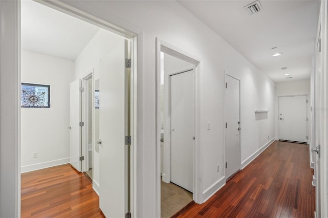 hallway with dark wood-type flooring