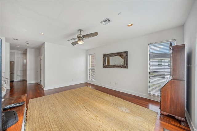 empty room with ceiling fan and dark hardwood / wood-style flooring