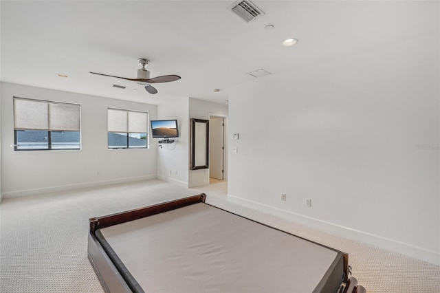 unfurnished bedroom with ceiling fan and light carpet