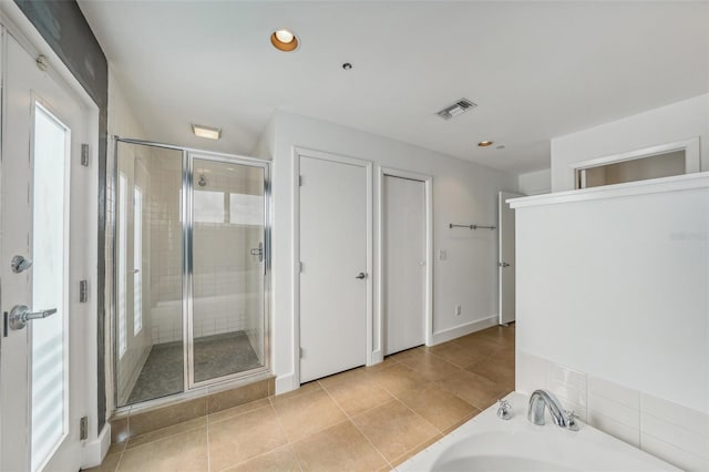 bathroom with tile patterned floors and plus walk in shower