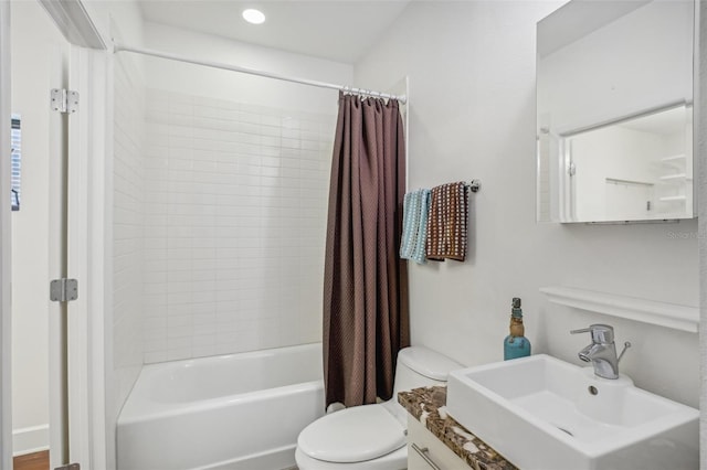 full bathroom featuring shower / bath combo, vanity, and toilet