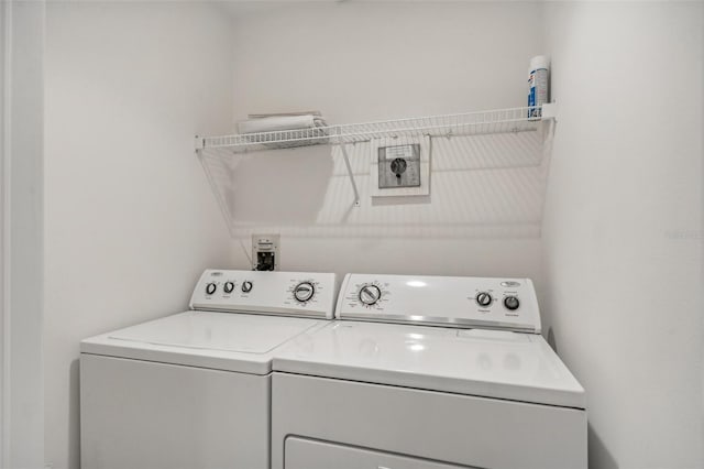 clothes washing area with independent washer and dryer