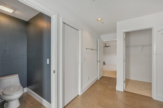 bathroom featuring tile patterned flooring and toilet