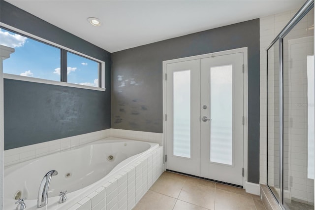 bathroom featuring tile patterned flooring, shower with separate bathtub, and french doors