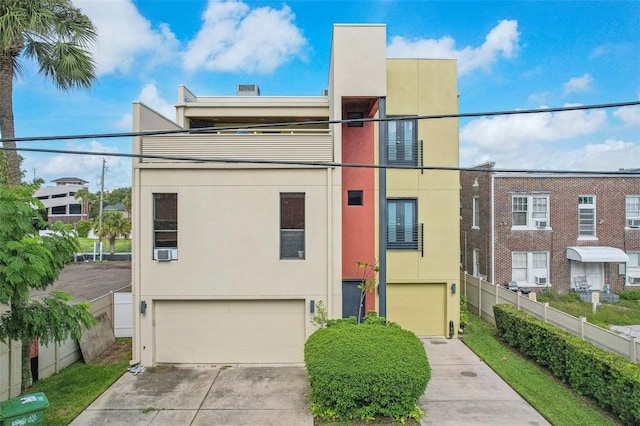 view of front of home with a garage and a balcony