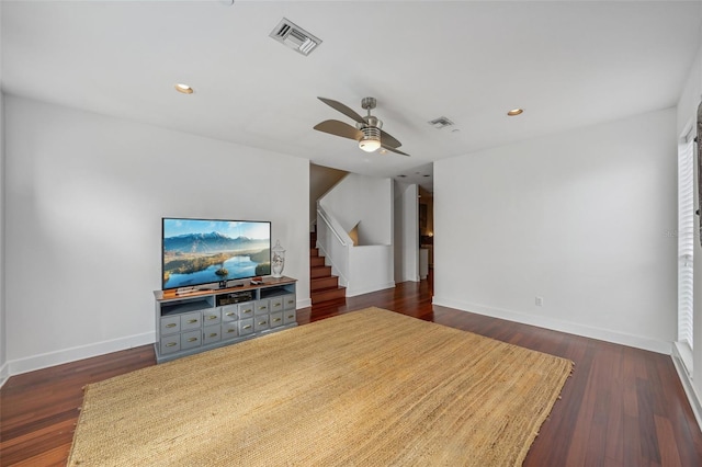 living room with ceiling fan and dark hardwood / wood-style floors