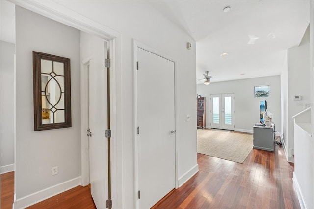 corridor featuring dark wood-type flooring and french doors