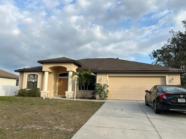 view of front of house with a front yard and a garage