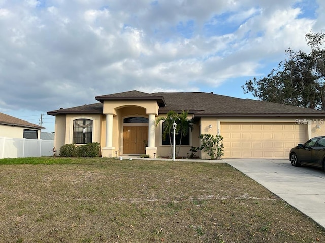 view of front of home with a front yard and a garage