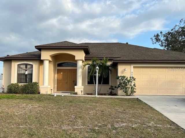 view of front facade featuring a garage and a front lawn