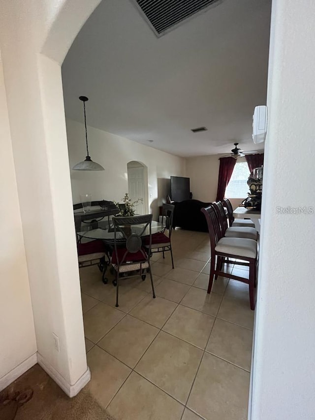 tiled dining area with ceiling fan