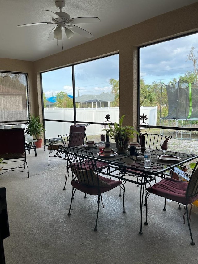 sunroom / solarium featuring ceiling fan and a mountain view