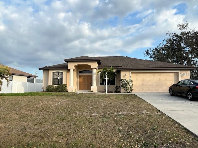 view of front facade with a garage and a front lawn