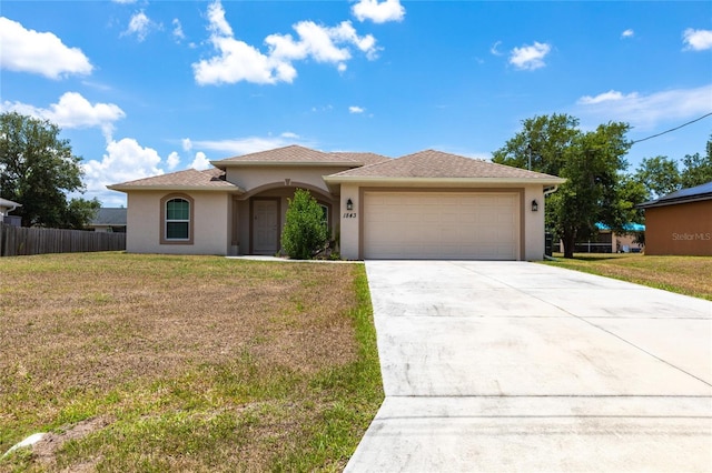 view of front of house featuring a garage and a front lawn