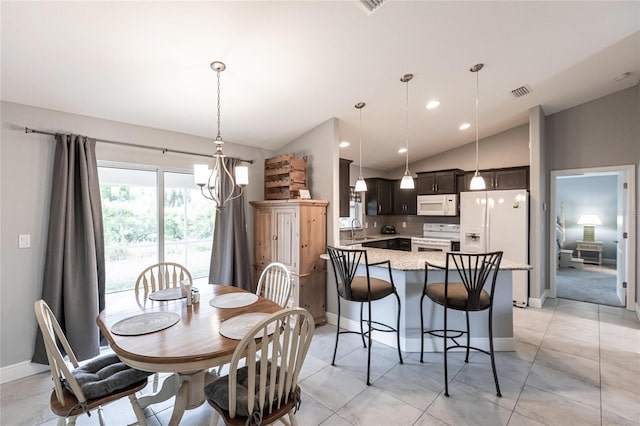 dining space featuring sink, light tile patterned floors, vaulted ceiling, and a notable chandelier