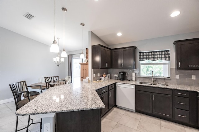 kitchen with kitchen peninsula, a breakfast bar, sink, dishwasher, and hanging light fixtures