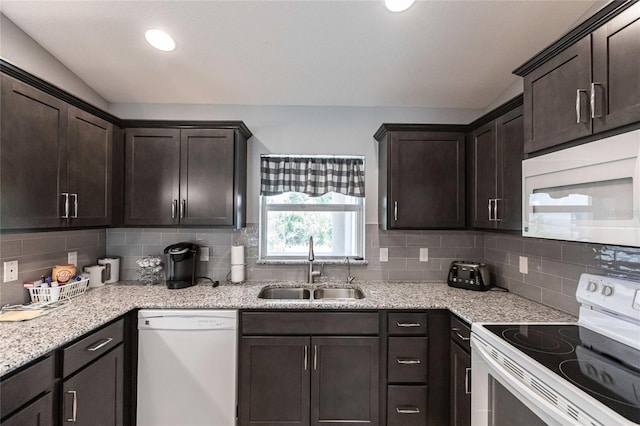 kitchen with decorative backsplash, white appliances, dark brown cabinetry, and sink