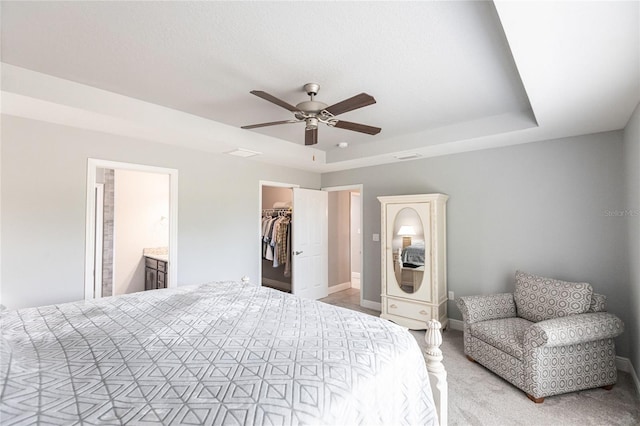 carpeted bedroom with a spacious closet, a closet, ceiling fan, and ensuite bathroom