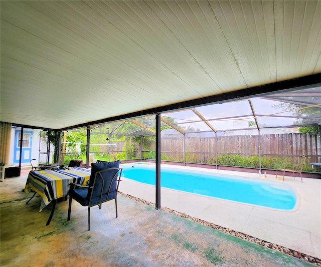 view of swimming pool with a lanai and a patio area