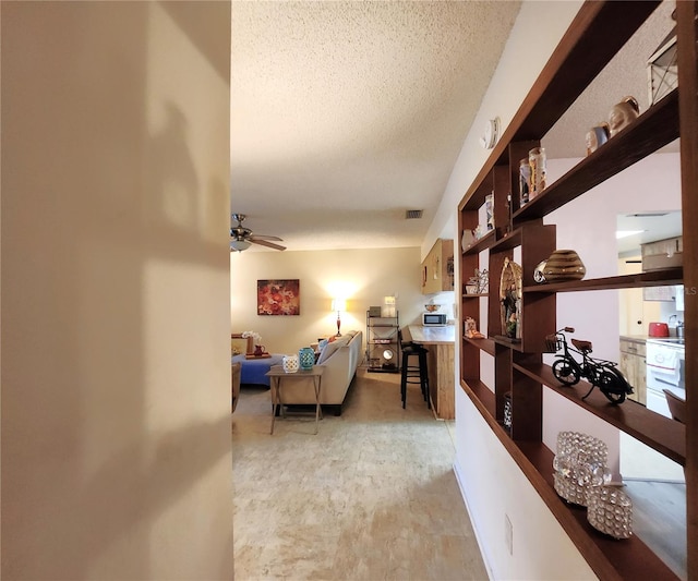 hallway featuring a textured ceiling