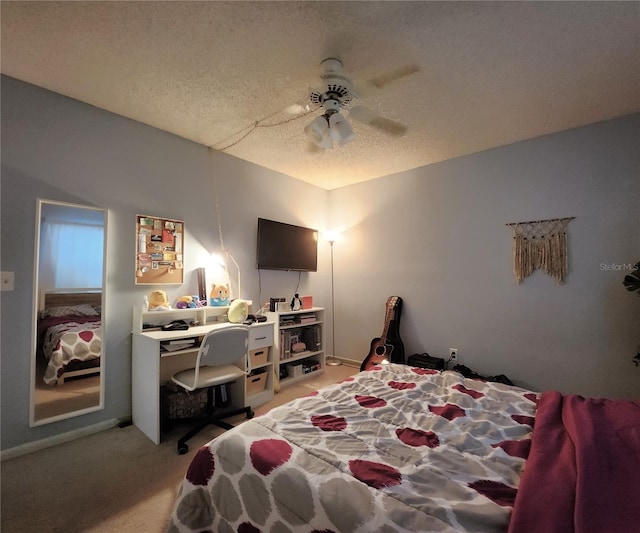 bedroom with ceiling fan, light colored carpet, and a textured ceiling