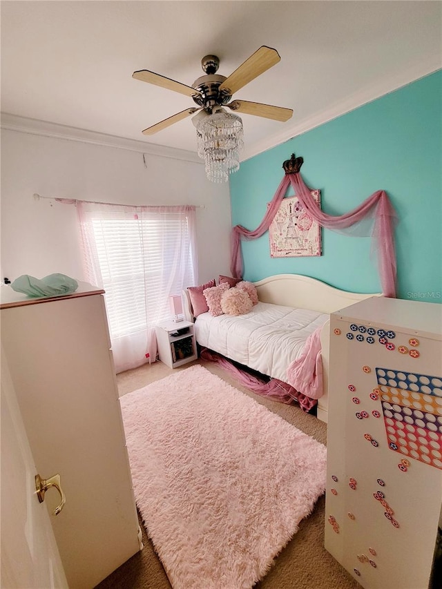 bedroom featuring dark colored carpet, crown molding, and ceiling fan