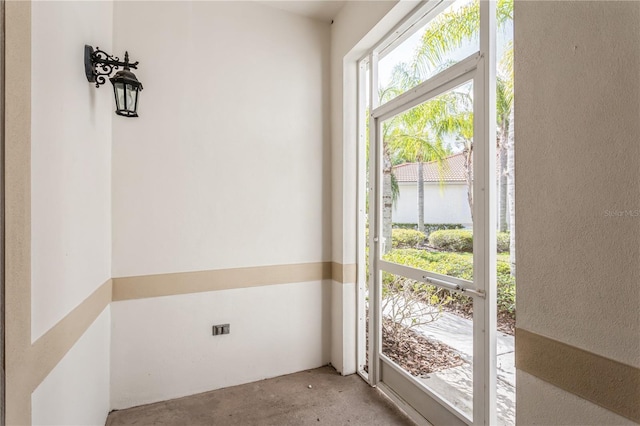 doorway with a water view and concrete flooring