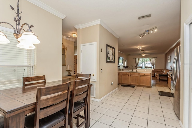 dining area with baseboards, visible vents, ceiling fan, crown molding, and light tile patterned flooring