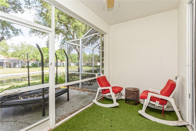 sunroom featuring ceiling fan and a wealth of natural light