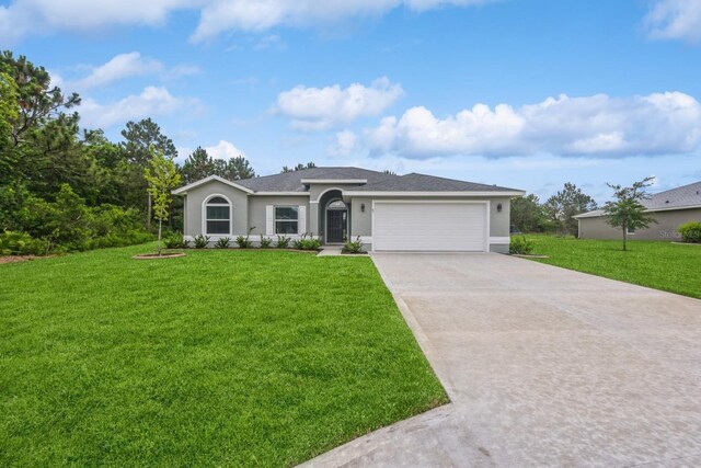 ranch-style house featuring a garage and a front lawn